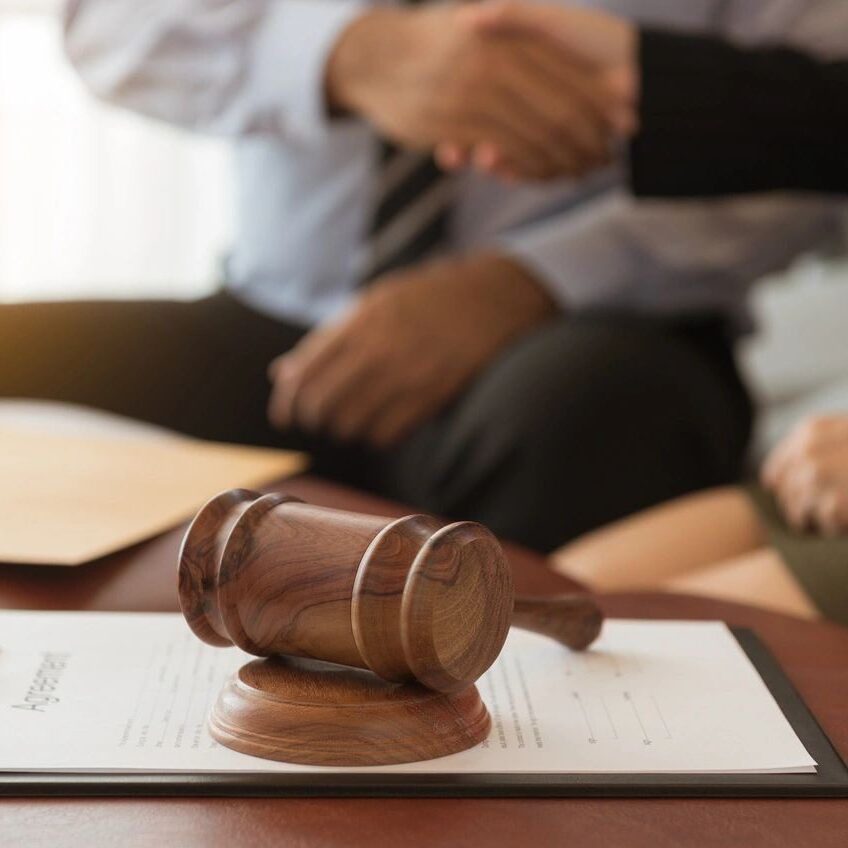 A judge 's gavel sitting on top of a table.